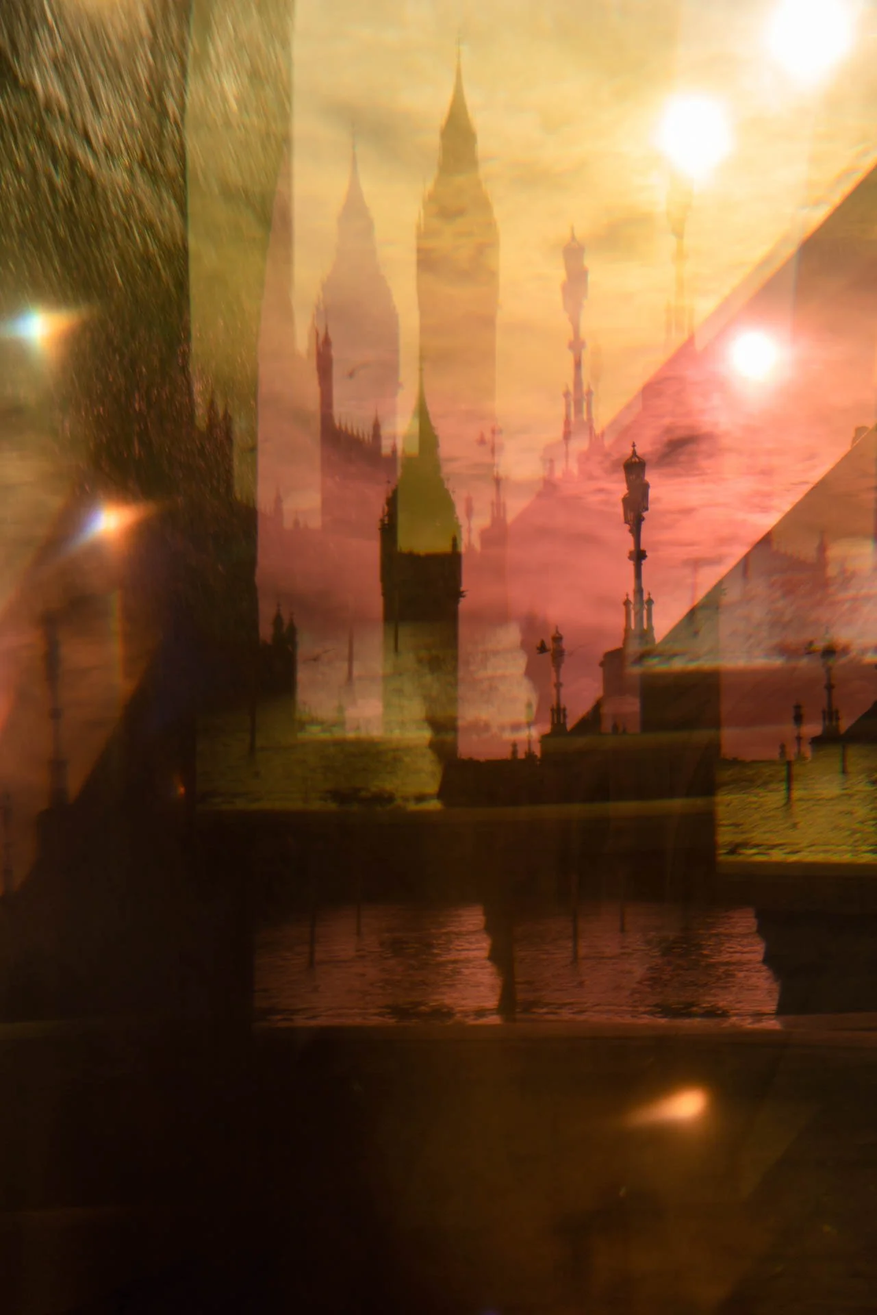 Abstract image with double exposure effect, featuring blurred silhouettes of Gothic architecture, lamps, and a sunset sky with vibrant colors.