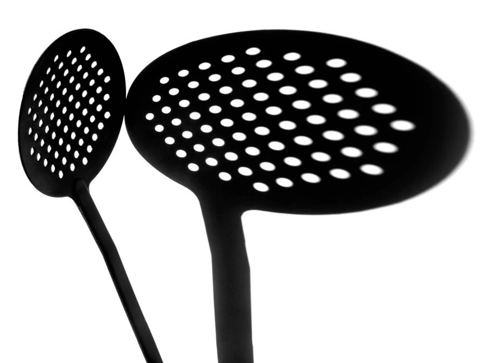 Two kitchen skimmers with perforated heads on white background