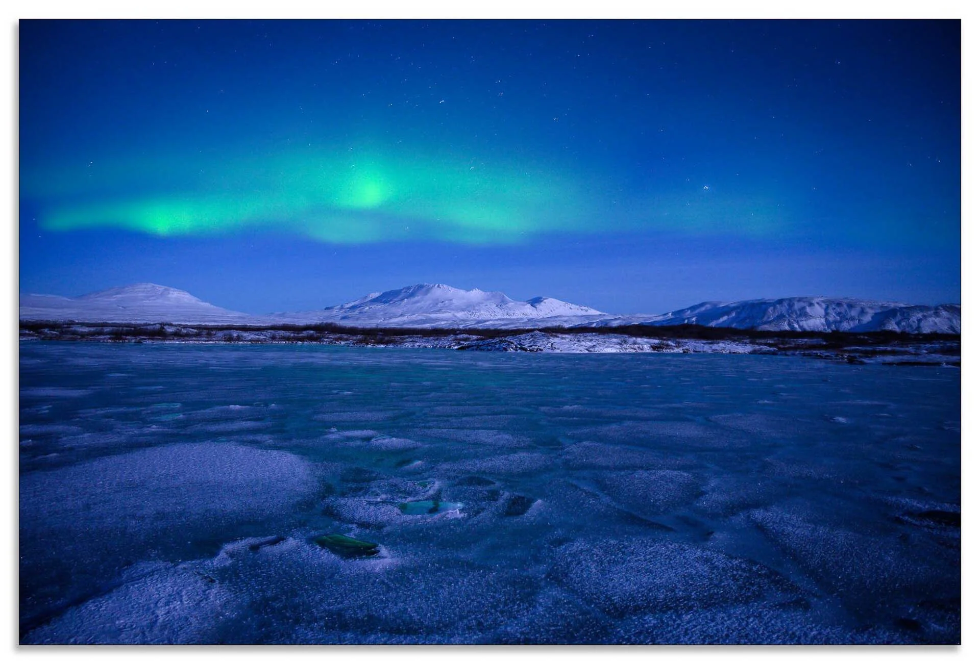 Frozen landscape with northern lights and mountains under a starry sky.