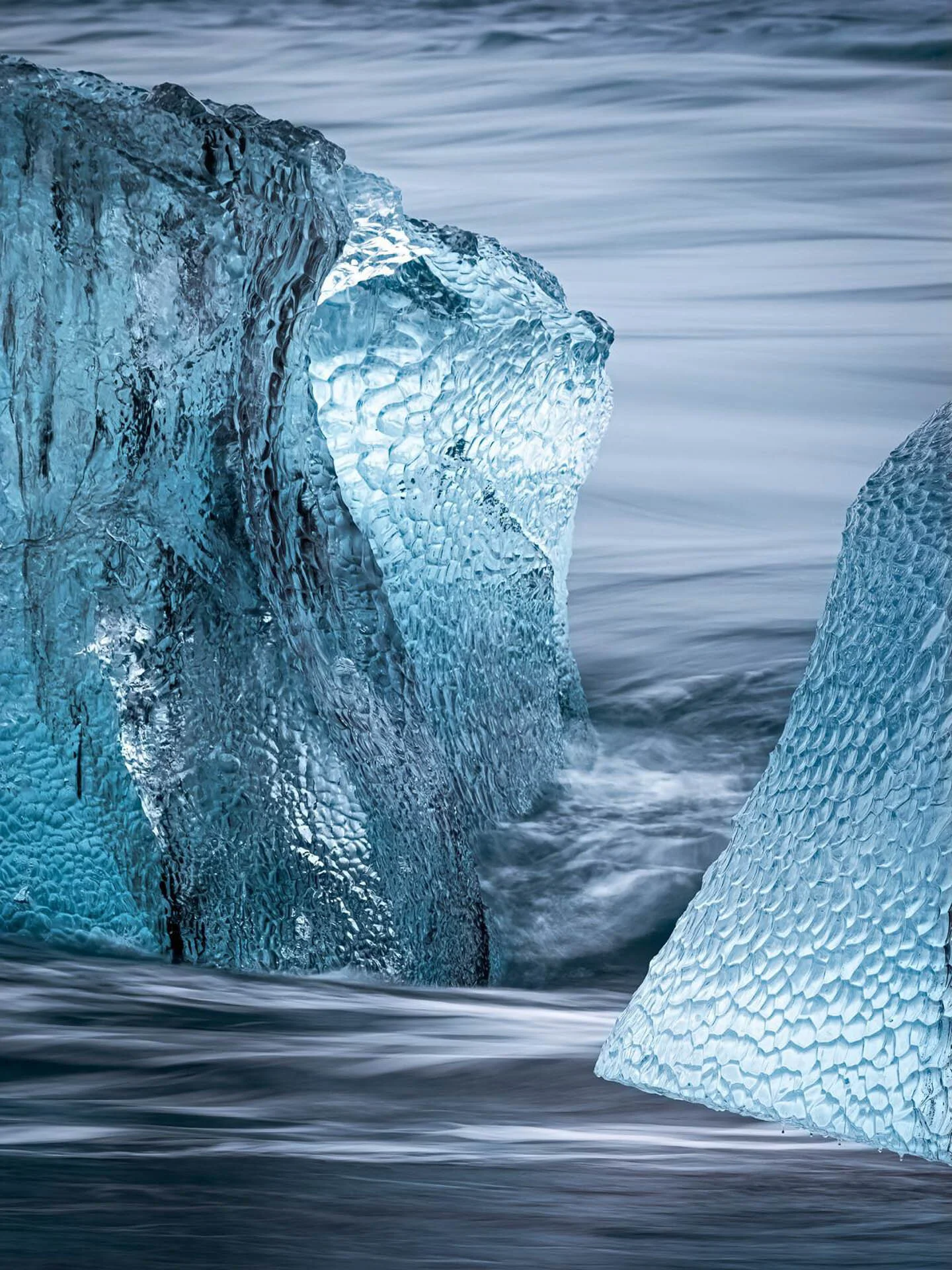 Close-up of icebergs with textured surfaces in flowing water
