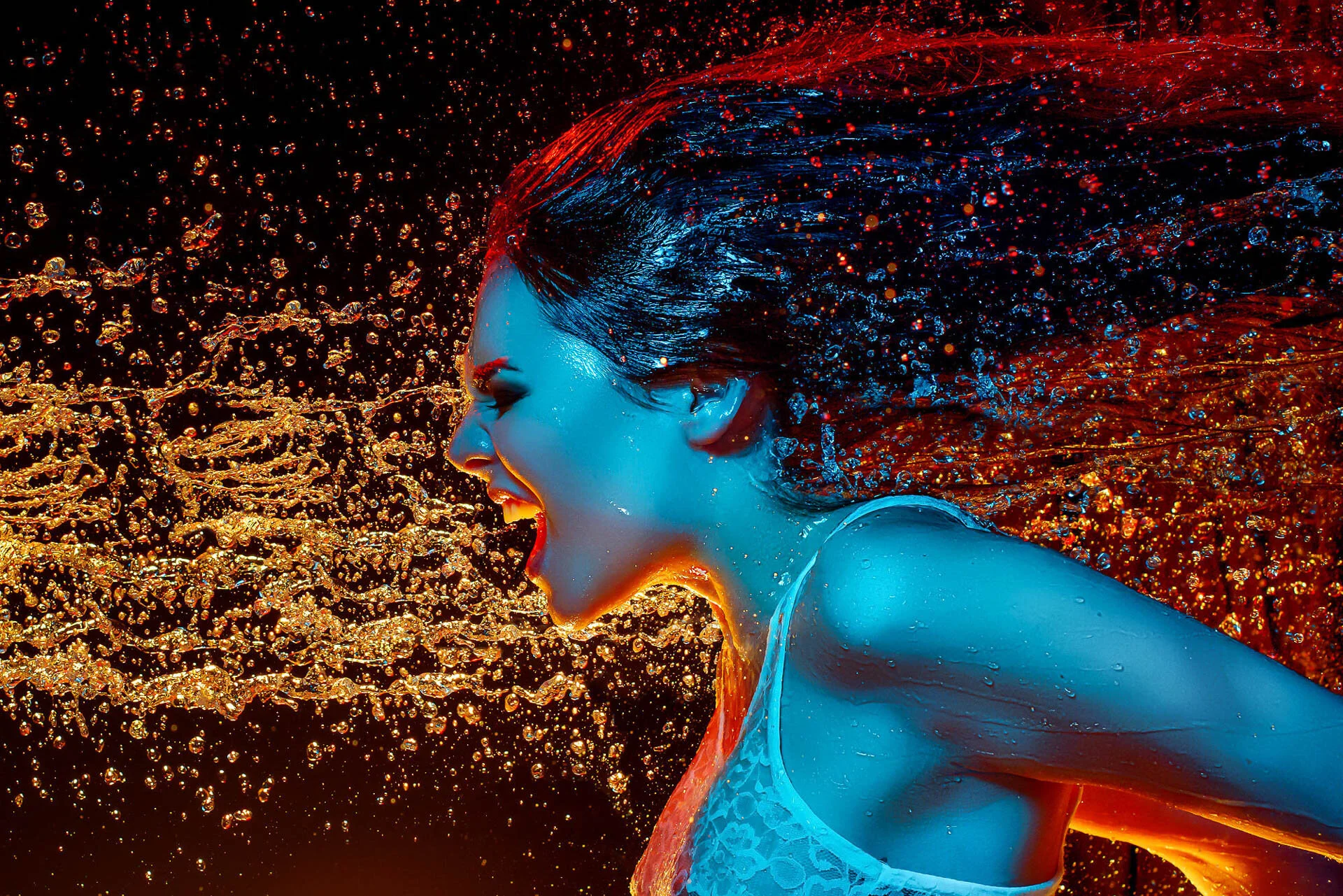 Woman in profile with water splashes, blue and orange lighting, vibrant dynamic scene.
