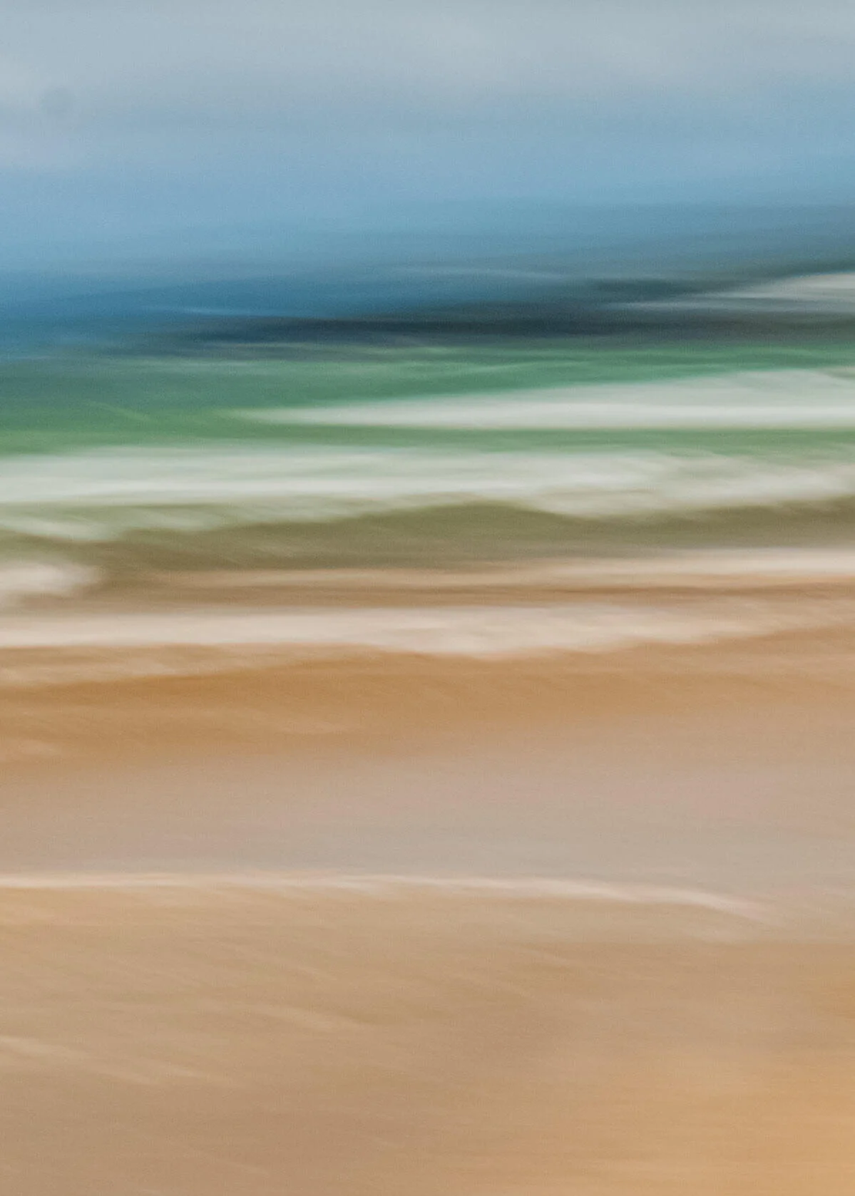Abstract blurred photo resembling a beach with sand and waves.