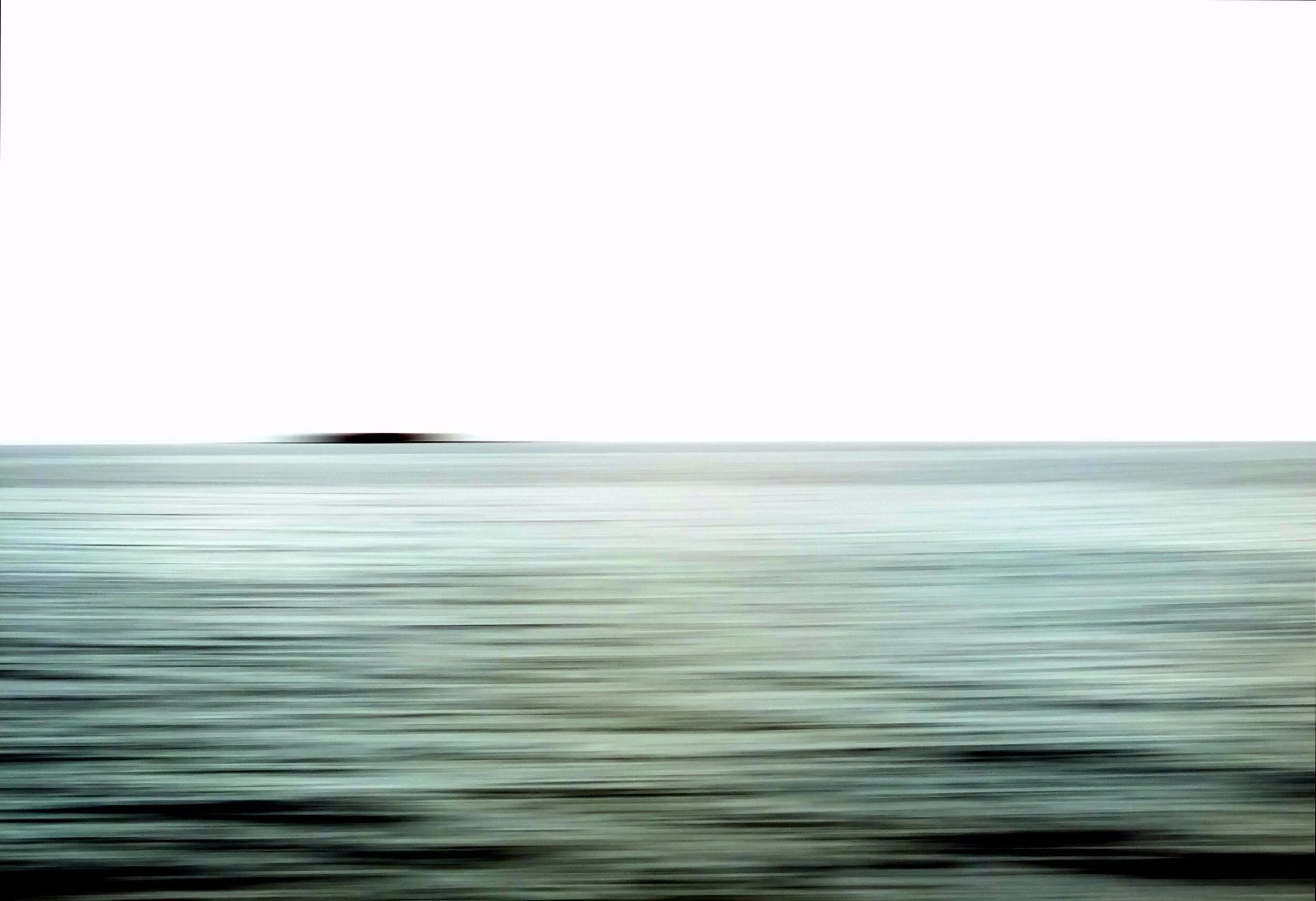 Blurred horizon over ocean with distant land