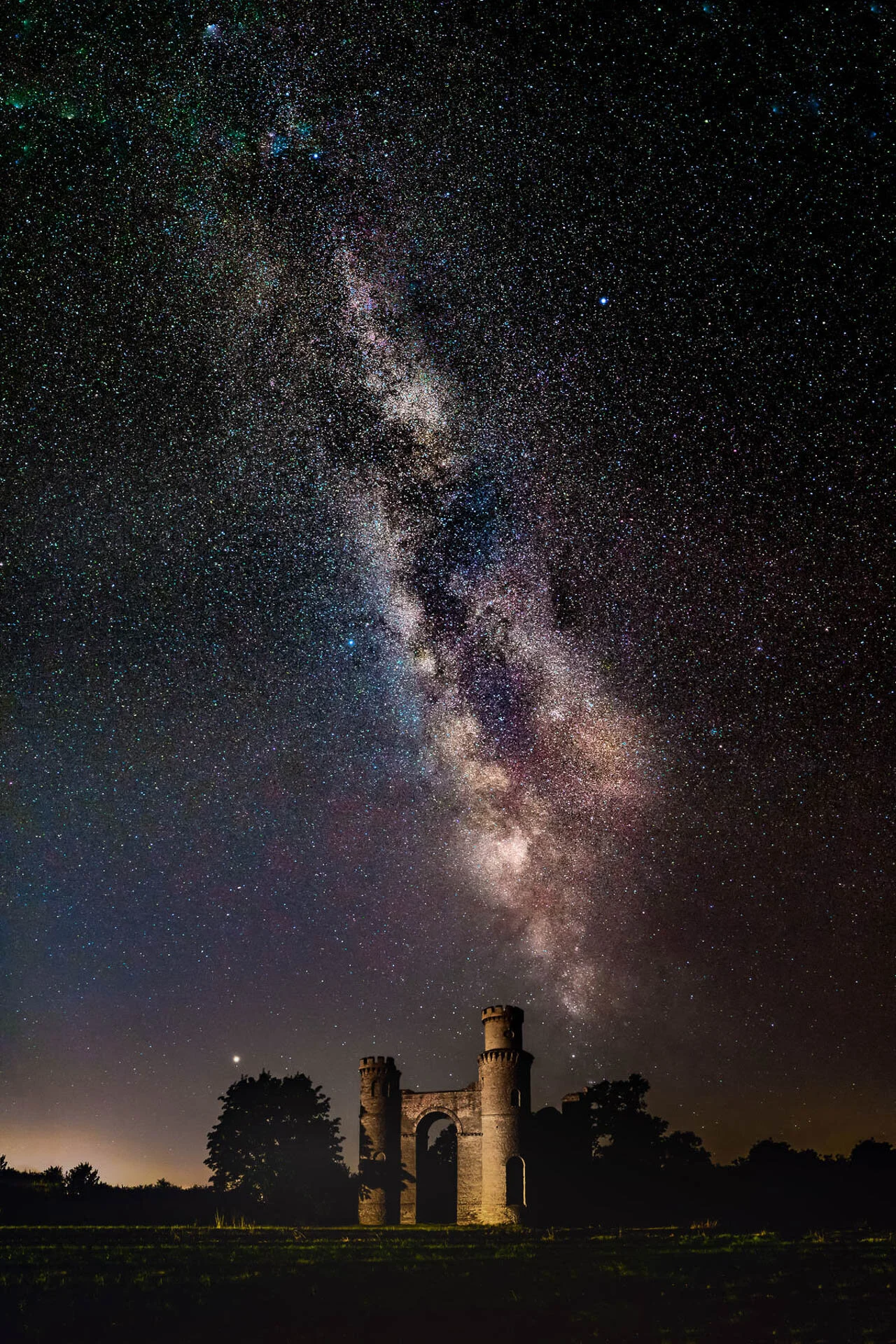 Starry sky with Milky Way over castle ruins at night
