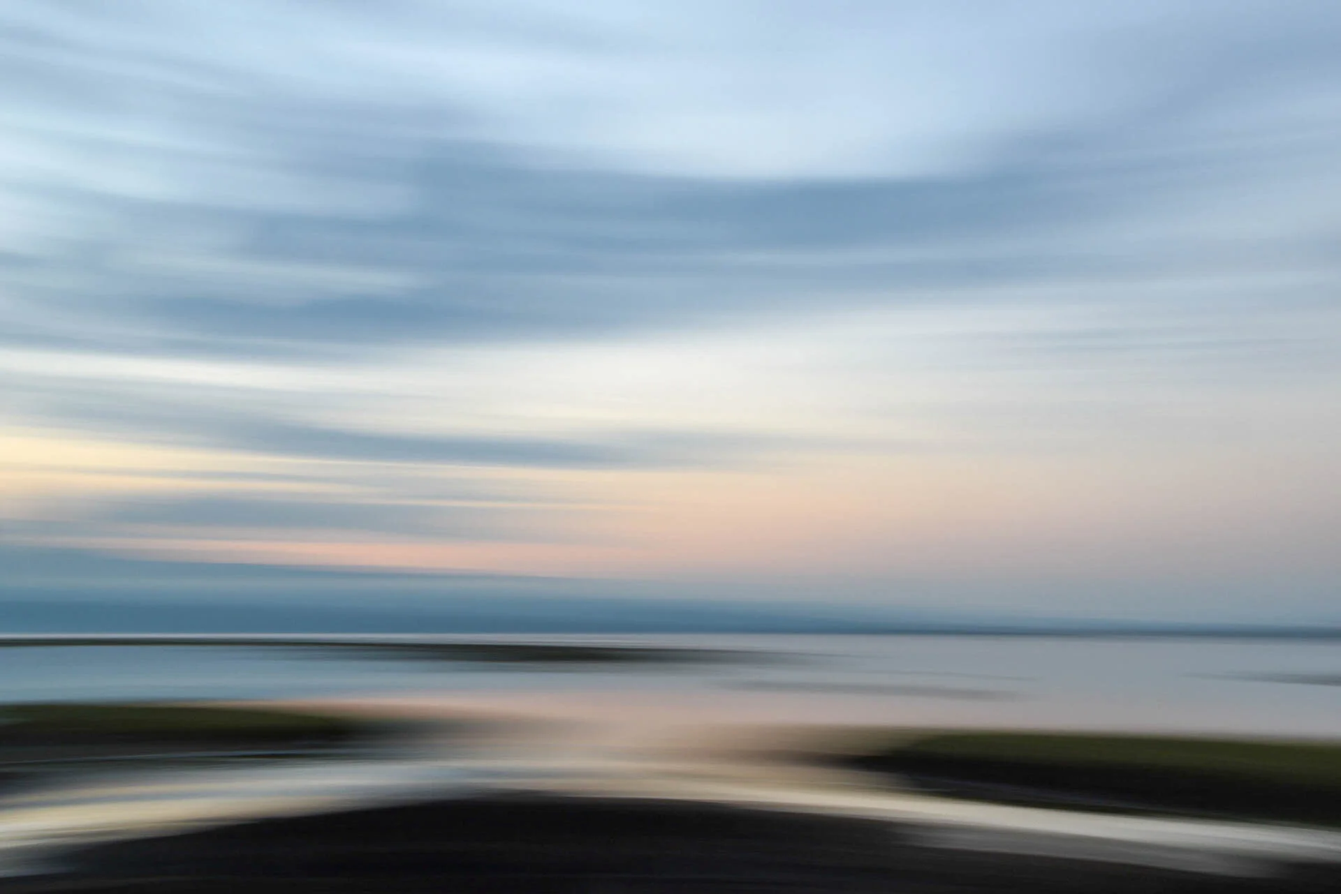 Abstract landscape with blurred sky, water, and horizon