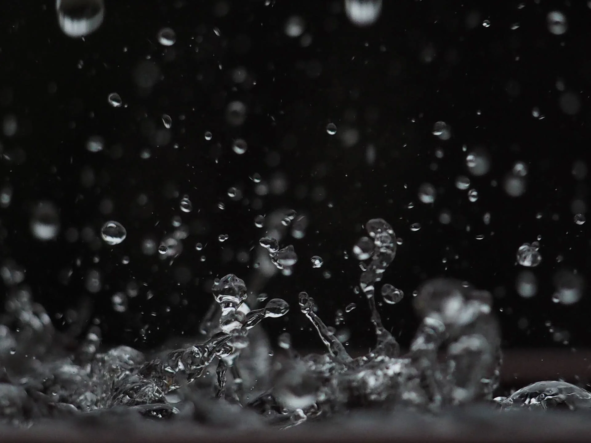 Water droplets splashing against a dark background