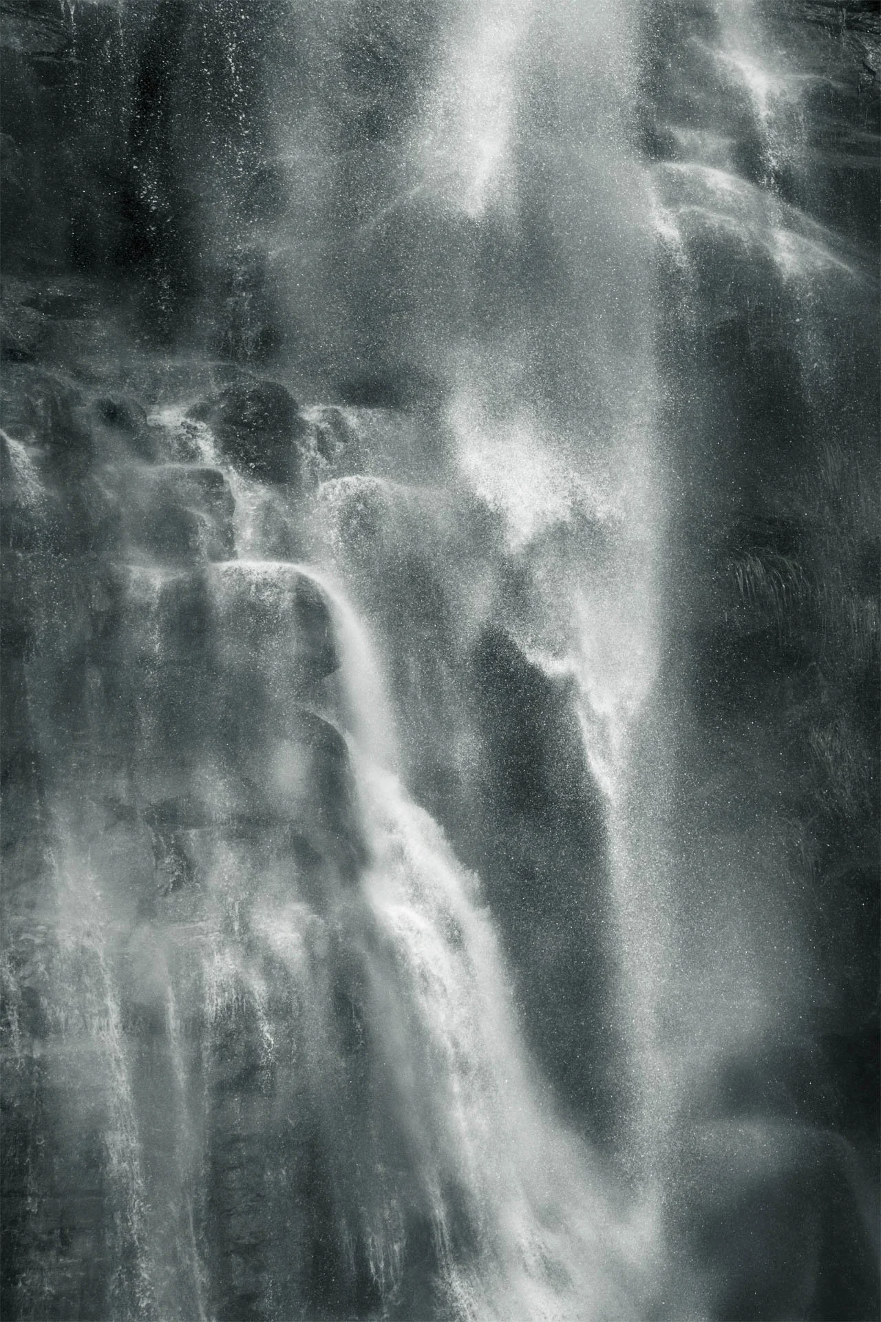 Cascading waterfall with mist and water droplets