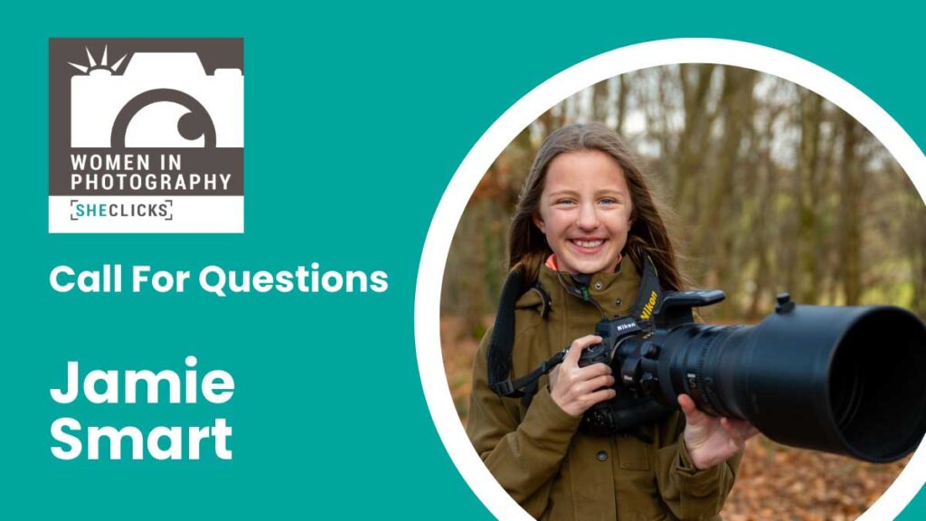 Promotional graphic for Women in Photography (SheClicks) with the headline “Call For Questions” and the name “Jamie Smart.” On the right, a smiling young woman stands outdoors in a wooded area holding a Nikon camera with a large telephoto lens, framed in a circular cutout against a teal background.