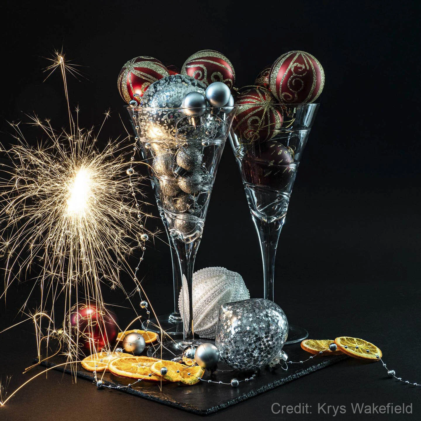 Close-up of a mushroom growing in a forest, with a focus on its gilled cap and slender stem, surrounded by pine needles and forest debris.